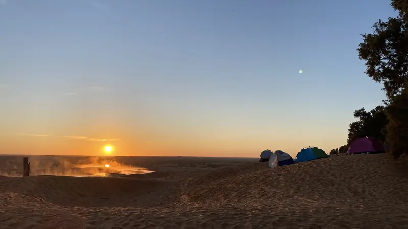 Tents at a Sahara desert camp at sunset, Ksar Ghilane, Tunisia